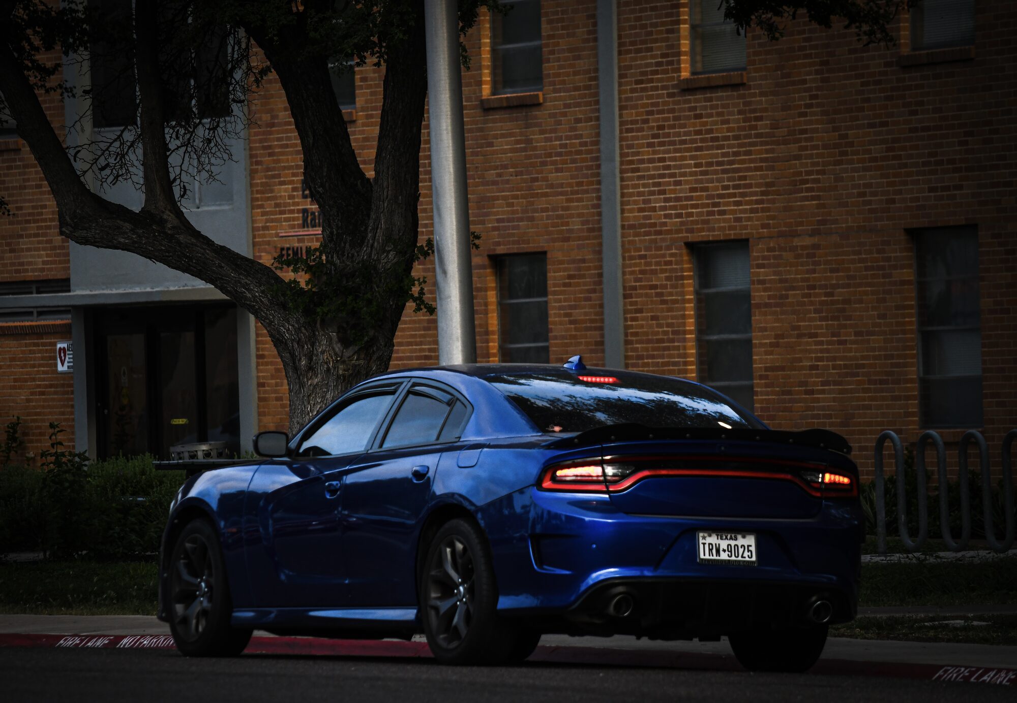 Rear of a blue Dodge Charger SRT at dusk